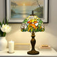 Tiffany-style stained glass table lamp with warm multicolor shade and bronze base on tabletop