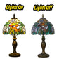 Tiffany-style stained glass table lamp with bronze base; warm multicolor shade, lights on/off view