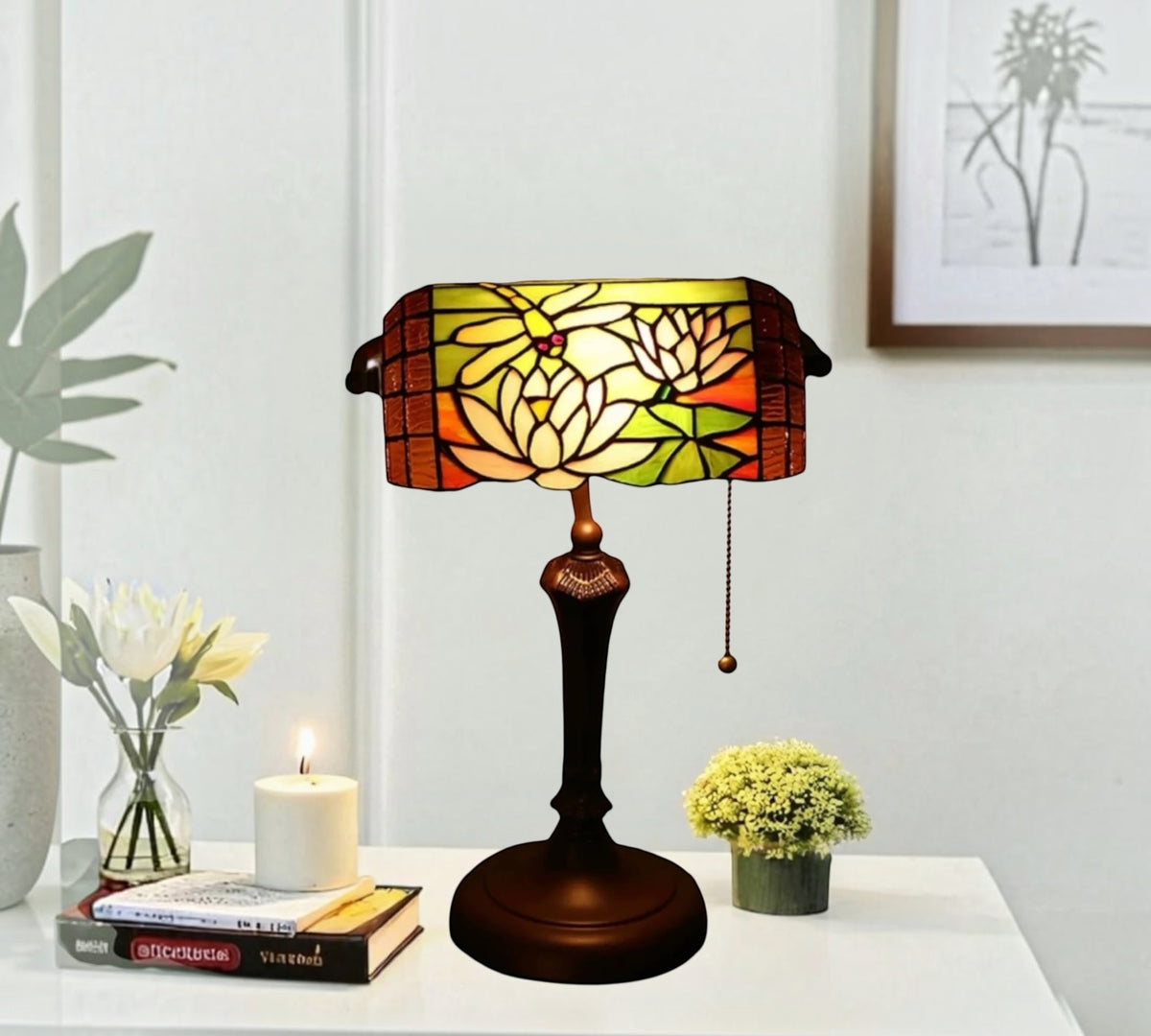 Stained glass table lamp with floral shade in amber, red, and yellow; dark metal base