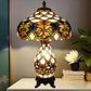 Multicolor stained-glass table lamp with flared shade and ornate resin base