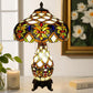 Tiffany-style stained-glass table lamp with narrow hourglass body and floral shade