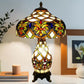 Tiffany-style stained-glass table lamp with domed shade and decorative resin stand
