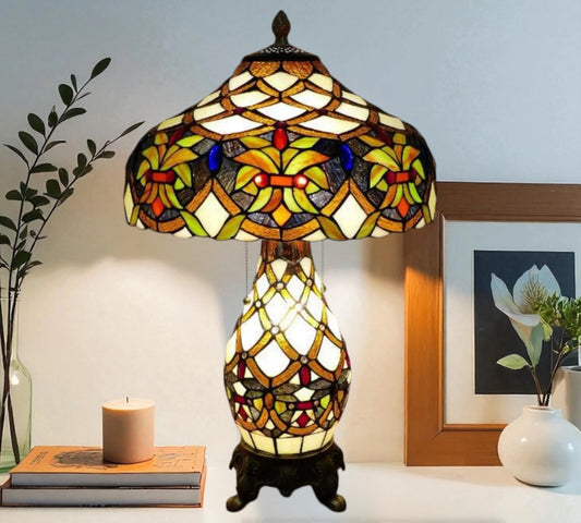 Tiffany-style stained-glass table lamp with domed shade and decorative resin stand