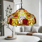 Multicolor floral stained-glass pendant lamp shade with hanging chain over sofa
