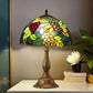 Tiffany table lamp with colorful stained-glass grape shade and bronze pedestal base