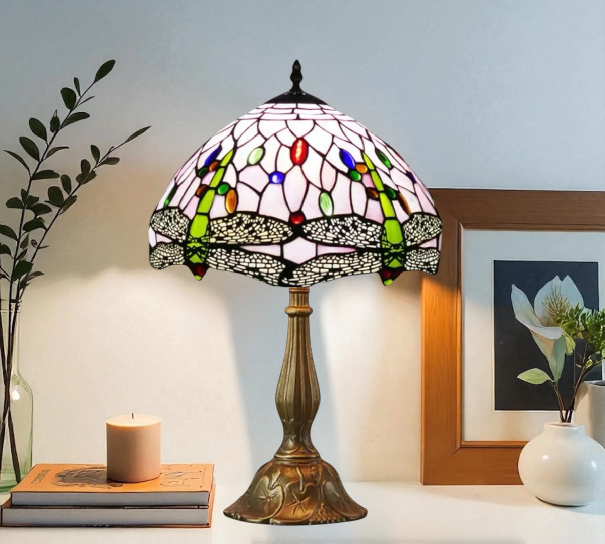 Stained-glass table lamp featuring a multicolor dome shade and bronze pedestal base